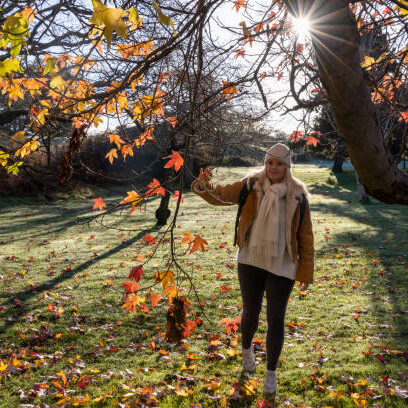 Mature woman explores urban park in winter Mature woman explores urban park in winter